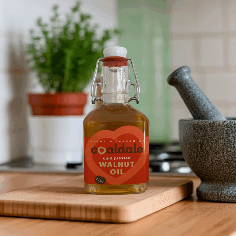 A full bottle of Walnut oil sitting on a table.