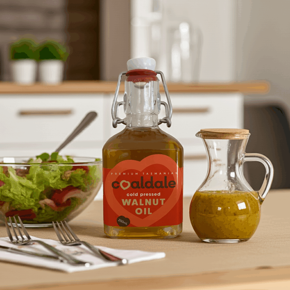 A full bottle of Walnut oil with bowl of salad sitting on a table.