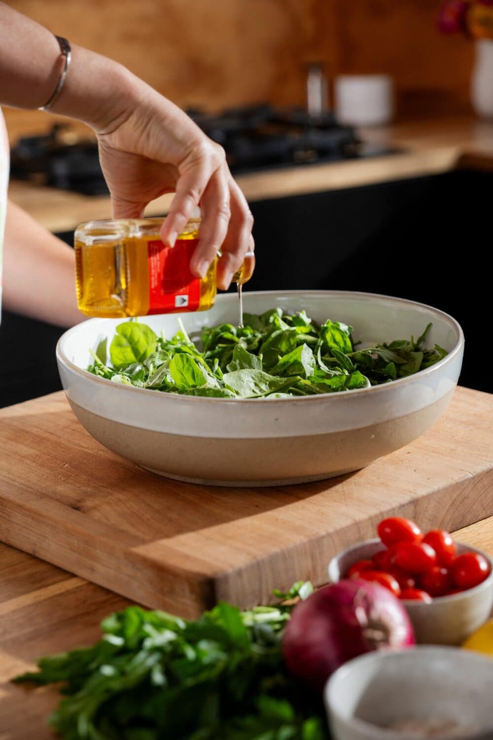 Pouring walnut oil into salad
