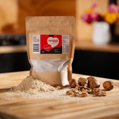 walnut flour sitting next to walnuts