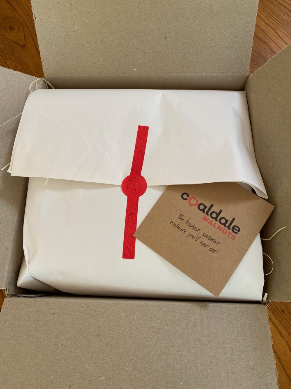 A wrapped up hamper containing a number of walnut products.