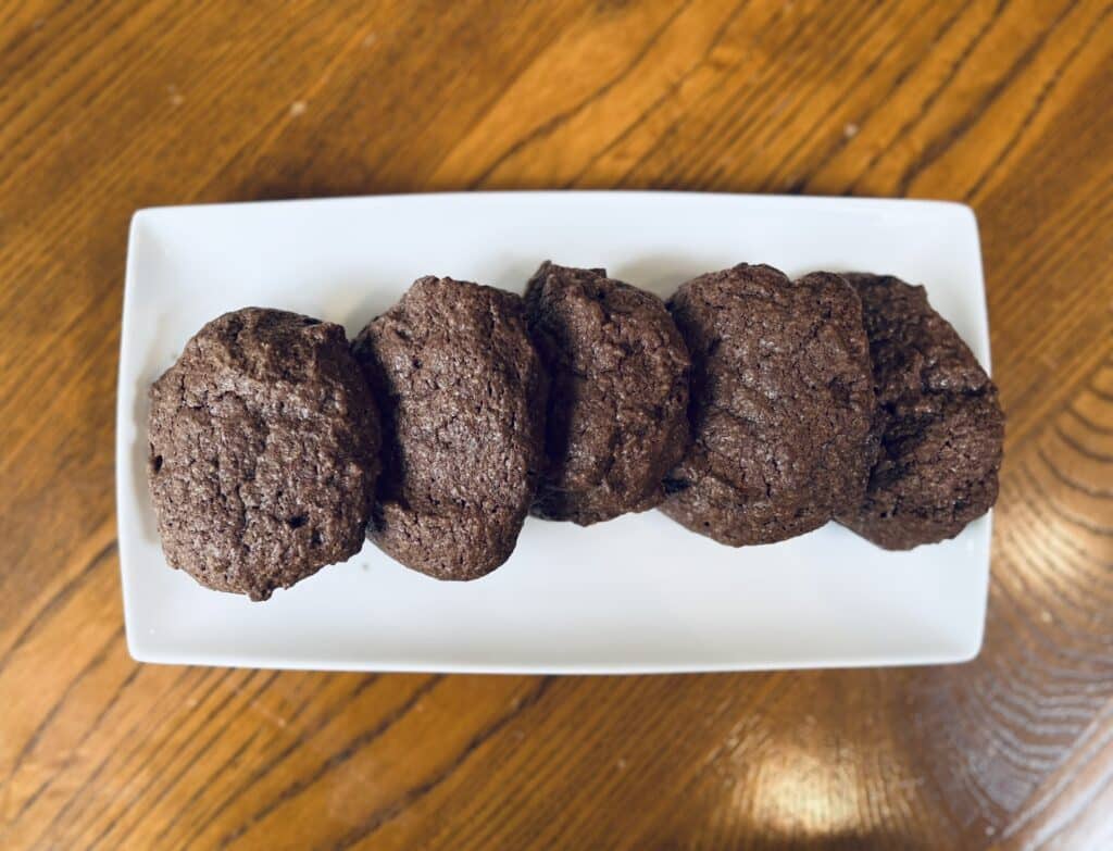 Chocolate walnut fudge cookies on a white plate